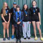 In this photo, from left to right, stand the first-place finishers of a novice girls squad from the Vashon Island Rowing Club: Etta Chait, Grace Pepper, coxswain Colin Simpson (front), Ren Colvos and Gwen Tomlinson.