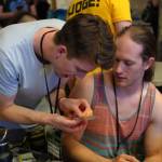 Charlie (left) and Abraham McBride run an alternate format of Netrunner they designed called Chimera at the World Championships (Saif Choudhury Photo).