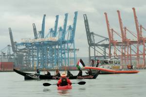 Logan Price photo
Coast Salish Water Warriors from the Puyallup and Nisqually nations keep a healthy distance from a U.S. Coast Guard vessel on Nov. 6, during a land and sea-based protest at the Port of Tacoma. Vashon islanders were among those who attended the protest by water to lend support.
