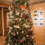 An artists tree stands just inside the studios door  a dazzling evergreen festooned with lights and small, inexpensive artworks by each member of the Waterworks collective (Courtesy Photo).