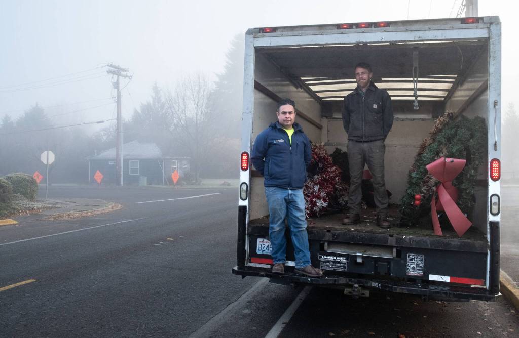 Eloy Carrillo and Nate Schafer distribute Island Christmas decorations for installation and hanging for the Vashon Chamber of Commerce. Terry Donnelly photo