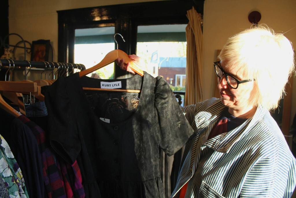 Erin Bowman shows a dress at her first-floor boutique Golden Afternoon at the Fuller Store. Alex Bruell photo