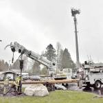 With the communication tower  where the fire districts ospreys used to perch  in the background, workers in 2022 used an auger to drill a deep hole for a new pole, complete with a newly constructed nest, to be erected behind the station (Jim Diers Photo).