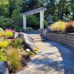 Designer Jil Stenn and landscape architect Bob Horsely have orchestrated a symphony of native plantings, fruit trees, flowers, and artistic hardscaping at Harborside Paradise. Photo courtesy Catherine and Gary Briggs.
