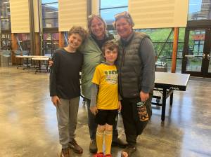 Elizabeth Shepherd Photo
Parents Lindsey and Leigh Anne McKeen, and their children Sabin (left) and Salinger (center) mustered smiles for The Beachcomber after Sabin and Salinger  both students at Chautauqua Elementary School  asked the school board and superintendent not to cut staff they said had helped them learn and grow.
