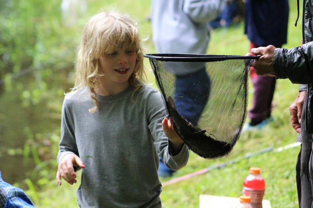 Alex Bruell photo
Griffin Simmons, 7, appreciates the trout he just caught at the fishing derby.