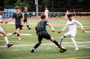 Dawn Stief photo
Mason Hanes takes on his opponent, with Isaac Newcomb and Captain Lewis Thompson supporting.