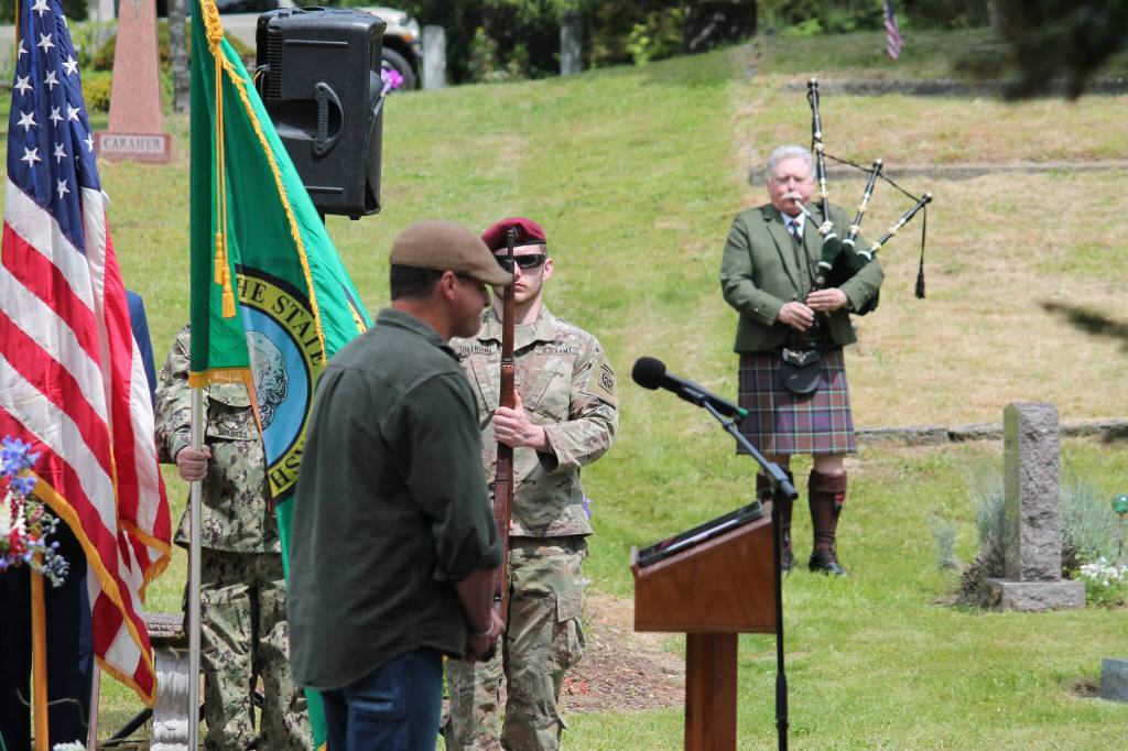 Tom Hughes Photo
As piper John Dally plays Amazing Grace, veteran Ryan Shannon stands in silence at the podium.