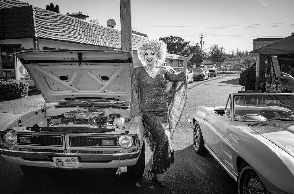 Sativa the Queen poses by a car on display the evening of June 7. Kent Phelan photo.