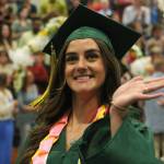 A student waves during the graduation ceremony at Vashon High School. (Alex Bruell photo.)