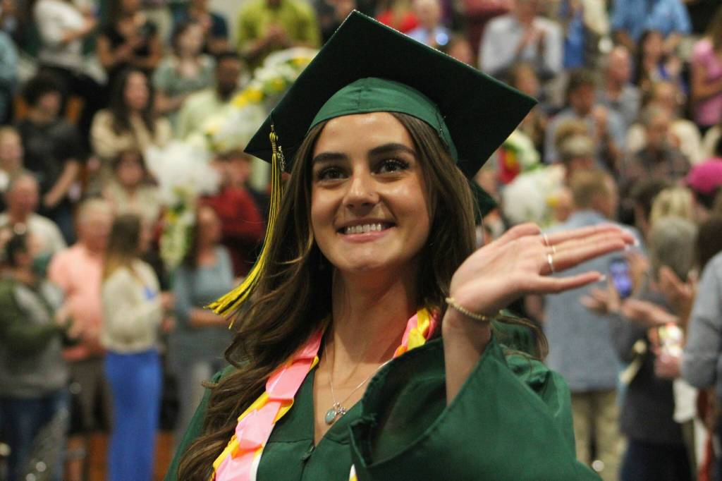 A student waves during the graduation ceremony at Vashon High School. (Alex Bruell photo.)