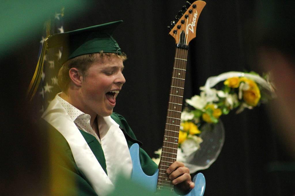 Graduate Eli Nelson shreds a volcanic guitar solo during graduation on June 14. (Alex Bruell photo.)