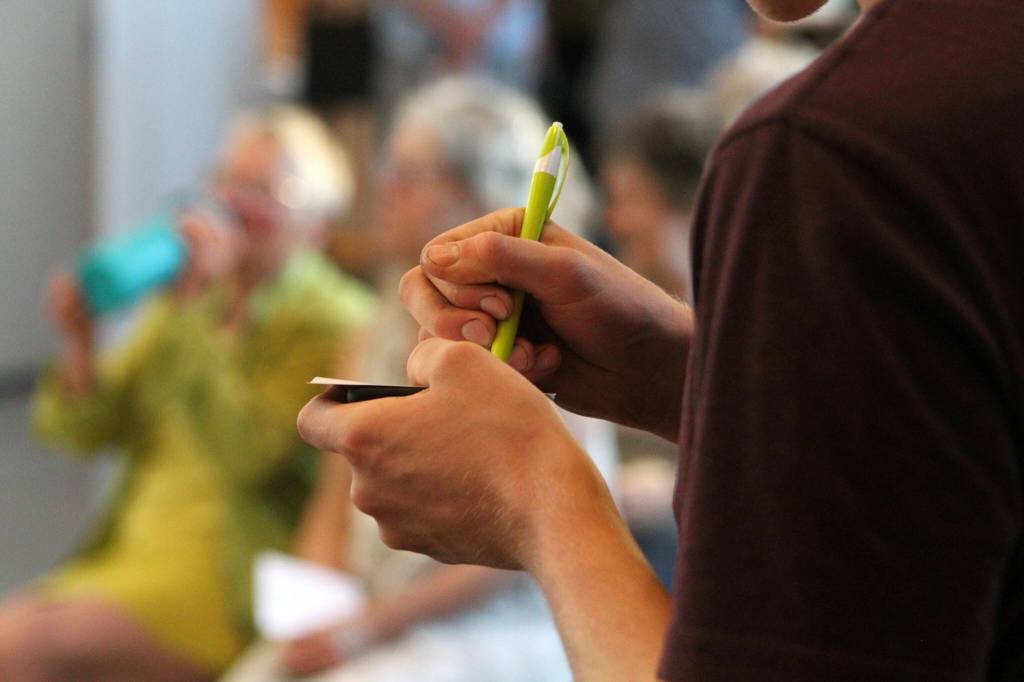 An attendee at Vashon Center for The Arts writes a letter as part of the Juneteenth celebrations workshop to support the upcoming Thunderbird Treatment Center. (Alex Bruell photo.)