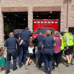Elizabeth Shepherd Photo
Islanders help first responders push a new ambulance into Station 55, on Bank Road, during a firehouse ceremony that dates back to the 1800s.
