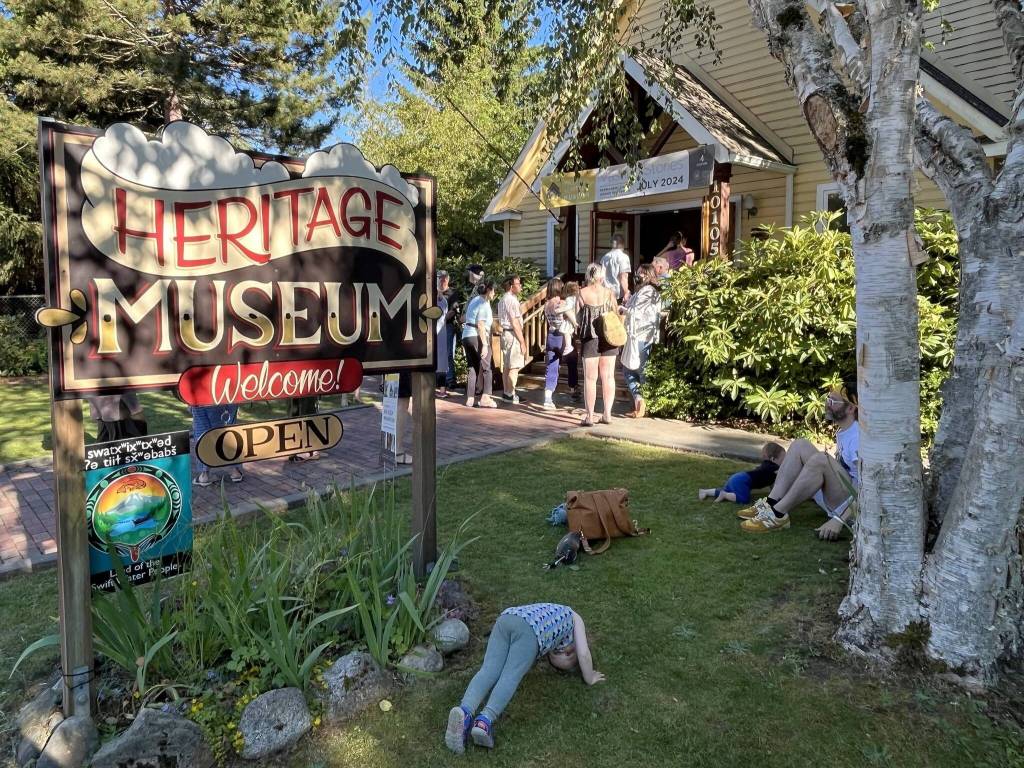 Kids frolic on the grounds of Vashon Heritage Museum, which reopened to the public on Friday following a major renovation of its permanent exhibition. (Jim Diers photo.)