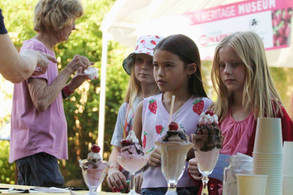 Arden, Lamai and Mia (all 9 years old) await receiving ice cream at the Vashon Island Heritage Museums ice cream social, a tradition of Strawberry Festival. (Alex Bruell photo)