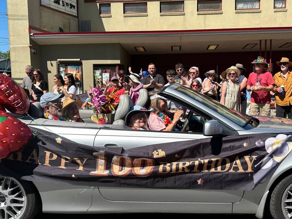 Marj Watkins, a mayoral candidate on her 100th birthday, enjoyed her ride in the parade. (Tom Hughes photo)
