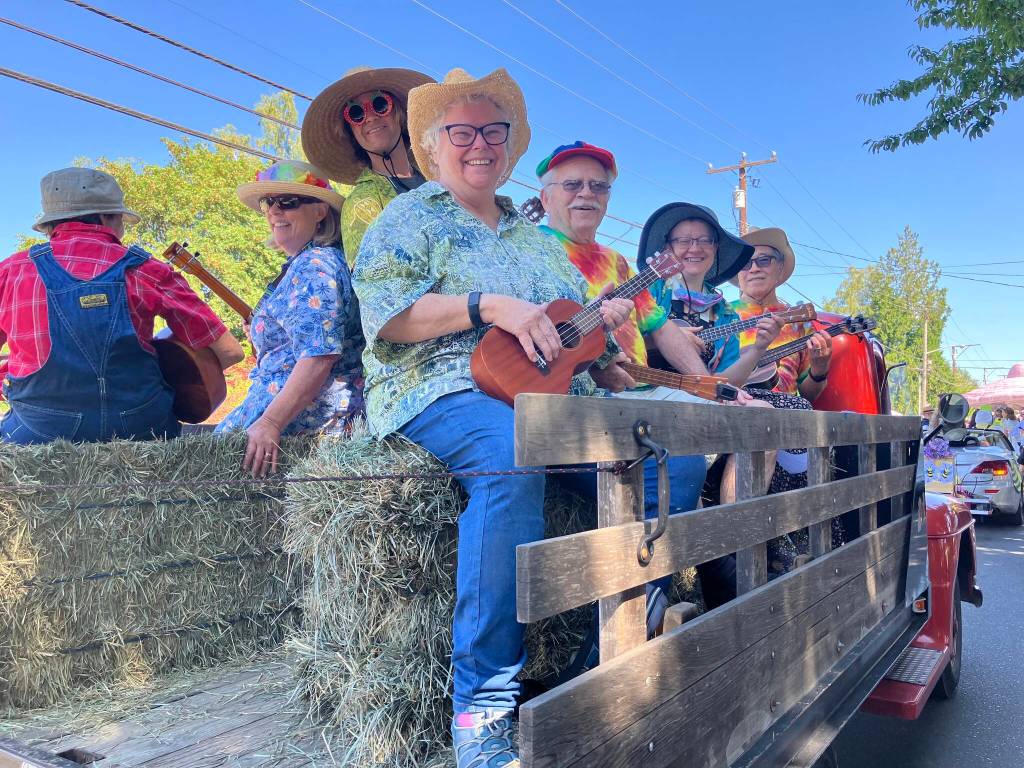Members of The Vashon Island Ukulele Society practiced playing their favorite tunes while waiting for the parade to begin. (Elizabeth Shepherd photo)
