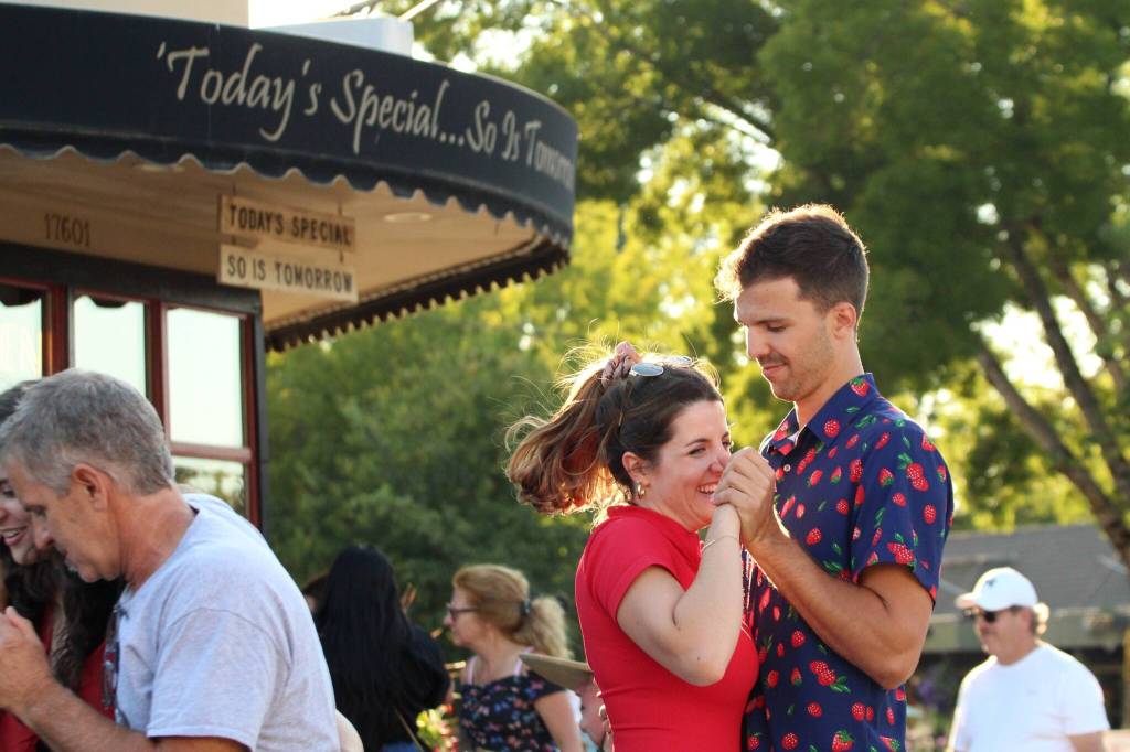 A pair dances in the afternoon light to the music of Portage Fill. (Alex Bruell photo)