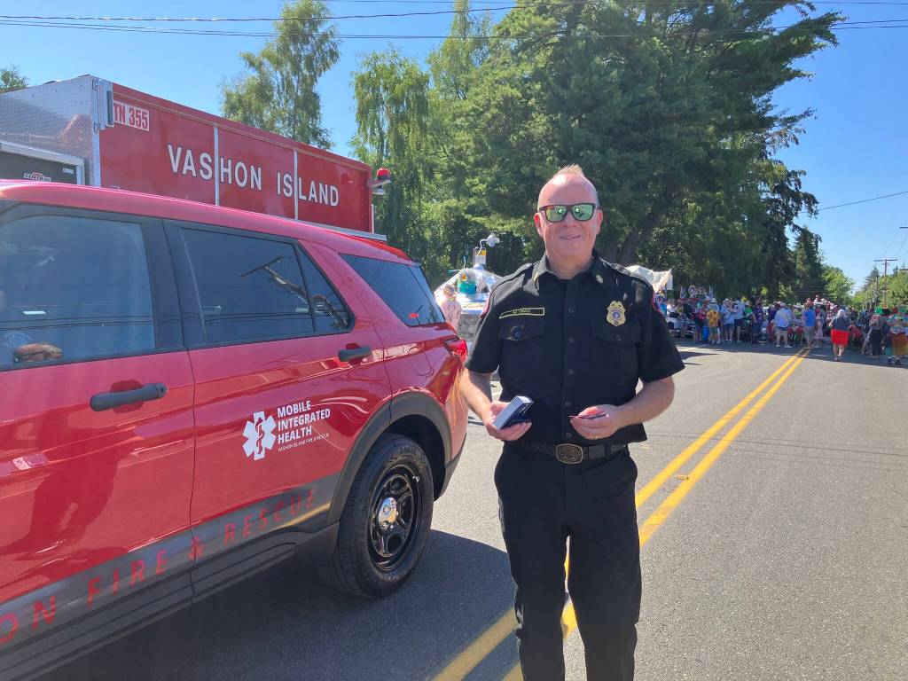 Fire Chief Matt Vinci, in the staging area for the Strawberry Festival parade, beside the fire districts Mobile Integrated Health vehicle. (Elizabeth Shepherd photo)