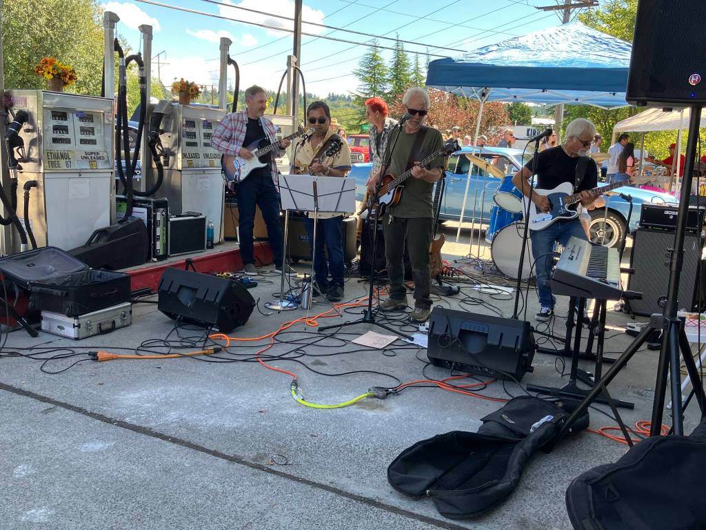 A reconstituted version of the Doiley Brothers rocked the stage set up by the gas stations retro pumps. (Tom Hughes photo)