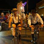 Jason Culp (left) and crew added a sparkling unicorn to their Amish buggy bike in a past Stupid Bike Night on Vashon. (Pete Welch photo.)