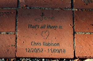 A brick at the Vashon Havurah's new memory garden reads: "Love / That's all there is." in remembrance of Chris Robison. (Alex Bruell photo)