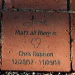 A brick at the Vashon Havurahs new memory garden reads: Love / Thats all there is. in remembrance of Chris Robison. (Alex Bruell photo)