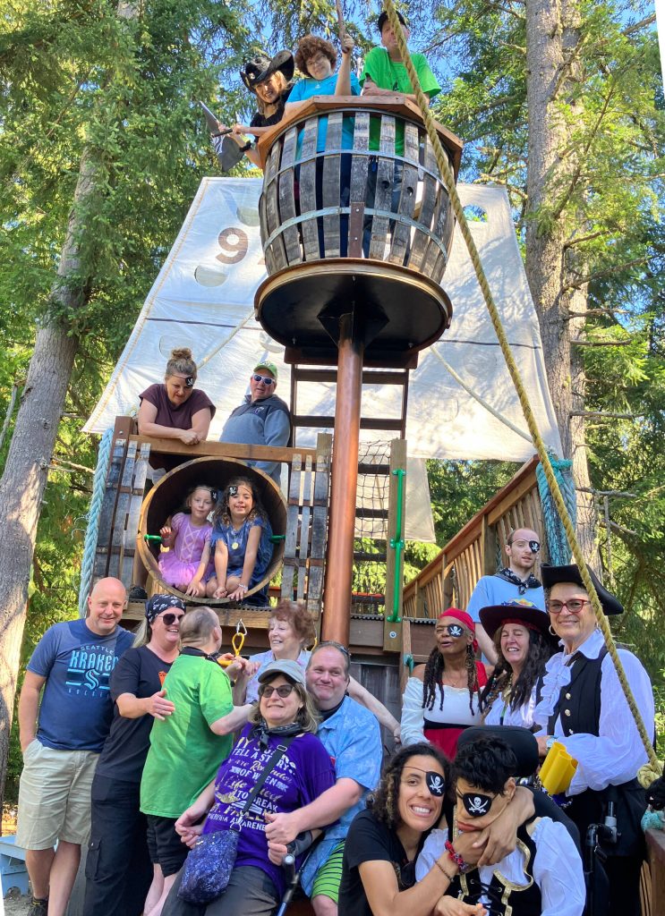 Members, friends and family active in Inclusion Island climbed and rolled aboard the pirate ship docked at Vashon Pirate Camp last Friday, during a special afternoon at the camp that included a treasure hunt, crafts, exploring, and snacks. (Elizabeth Shepherd photo)