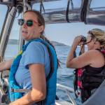 World Vets Field Responder EJ Verble prepares to make landfall while Vashon Nature Center Science Director Bianca Perla looks for the remains of the gray whale through her binoculars. (Alex Bruell photo)