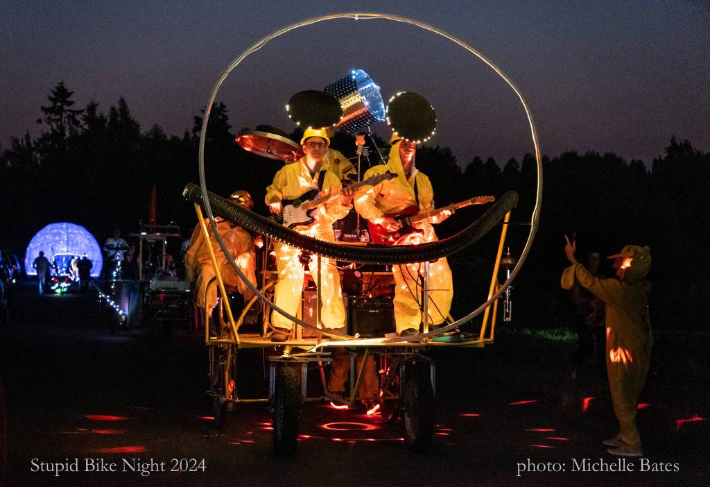 Andre Sapp, Shawn Carkonen and Bill Moyer rock out on a bike pedaled by Henry Haselton & Derrick Reed. The Band Bike was built by the Stupid Bike Club. (Michelle Bates photo)