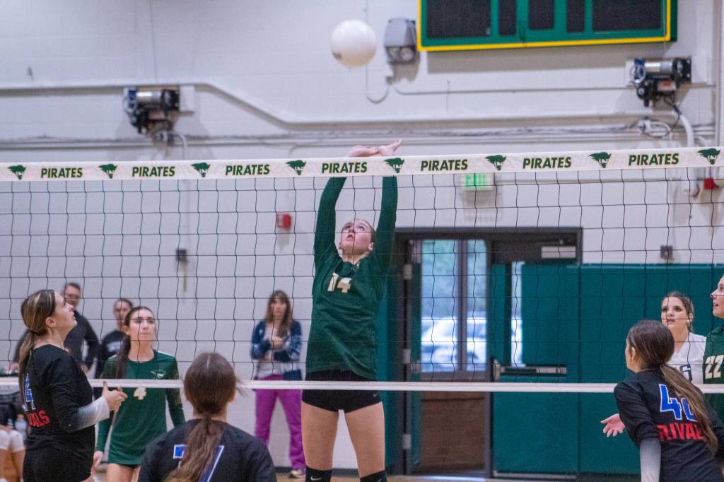 JV Junior middle hitter #14 Dempsey Moog jumps for it against East Jefferson High School at Vashon on September 25. (Alex Bruell photo)