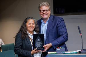 Esther Lucero (Diné), president and CEO of the Seattle Indian Health Board, is presented with the 2024 King County Recovery Champion Award on Sept 24. Councilmember Reagan Dunn presented the award. (Photo by Thomas Hawthorne, King County)