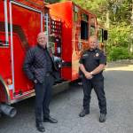 Fire Chief Matt Vinci (left) and Division Chief Ben Davidson were all smiles outside the truck at Inspiration Point, minutes after it had arrived on Vashon. (Elizabeth Shepherd photo)