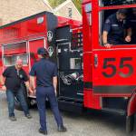 Mike Bredice, the fire districts fleet manager (facing camera), looked like a kid in a candy store as he examined the new fire truck, with Firefighter/EMT Dawson Allen close by and Firefighter/EMT West Soares inside the engine. (Elizabeth Shepherd photo)