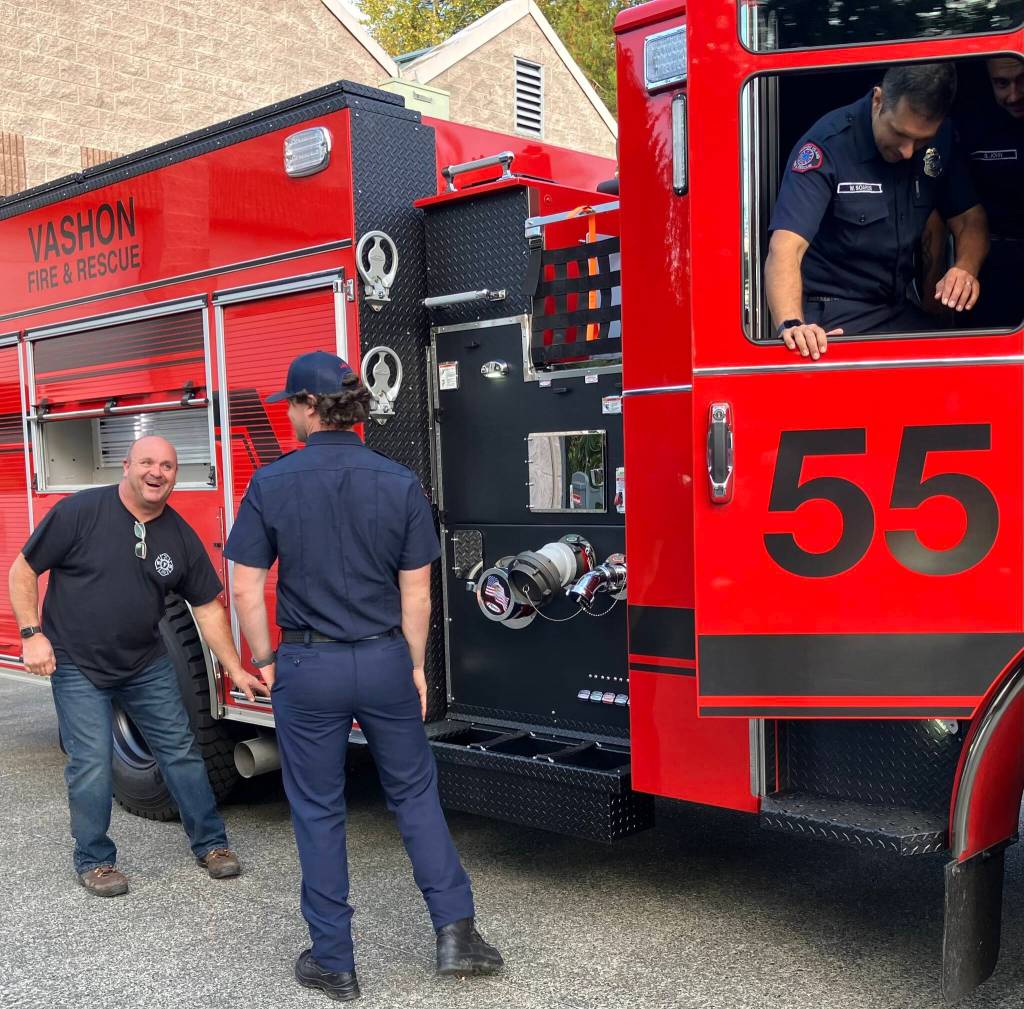 Mike Bredice, the fire districts fleet manager (facing camera), looked like a kid in a candy store as he examined the new fire truck, with Firefighter/EMT Dawson Allen close by and Firefighter/EMT West Soares inside the engine. (Elizabeth Shepherd photo)