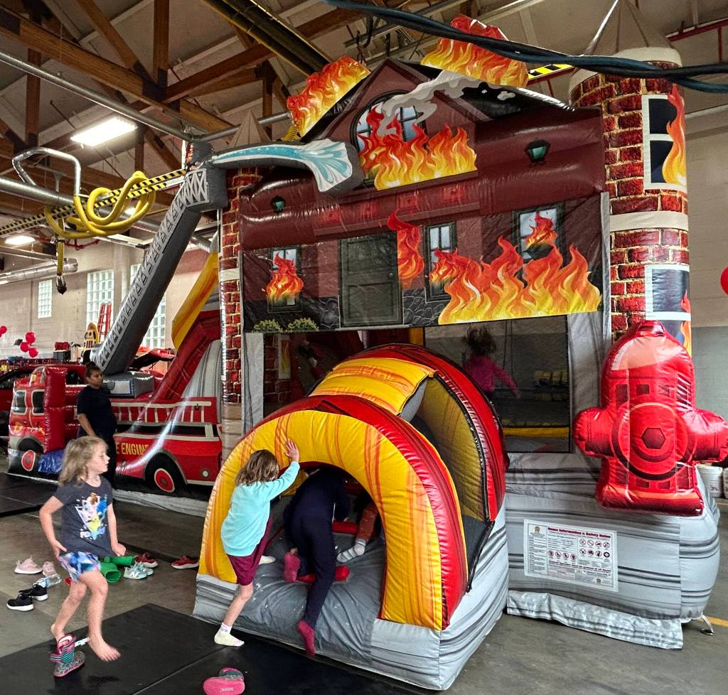 Family-friendly fun at the fire districts open house included a pancake breakfast served by local Rotarians and a firehouse-themed bouncy castle. (Tom Hughes photo)