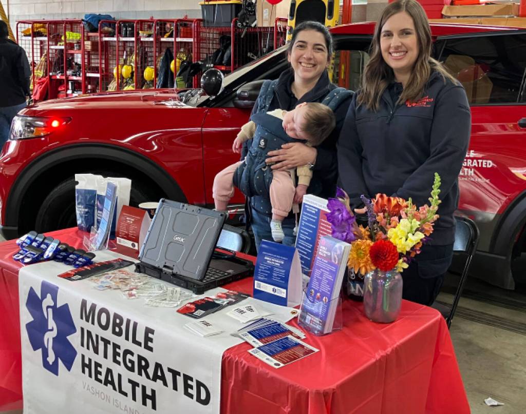 Administrator Lilie Corroon, with her sleeping baby Ruby in tow, and registered nurse Ashley Soares answered islanders questions about Mobile Integrated Health at the open house. (Elizabeth Shepherd photo)