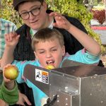An apple pressing station brought joy to young and old at Cider Fest. (Tom Hughes photo)