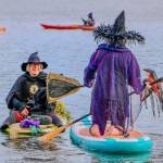 Aspen Anderson photo. Jensen Point transforms into a spectacle of pointed hats and flowing capes as Vashon’s witches take to the water for their annual paddle.