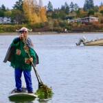 A standout witch catches eyes with a vibrant, colorful mask, bringing an extra splash of magic and mystery to the Halloween paddle at Jensen Point. (Aspen Anderson photo)