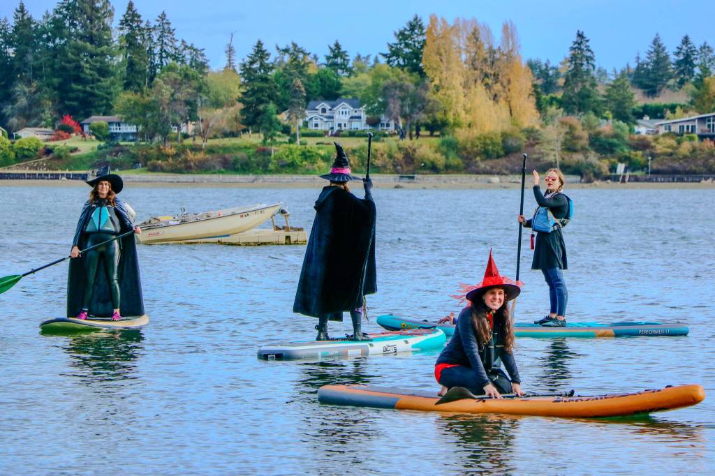 Paddlers decked in their best witch attire bring an annual Halloween tradition to life at Jensen Point, turning the waterway into a scene of spooky, floating fun. (Aspen Anderson photo)