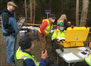 Courtesy photo
This ham radio team set up to support a command post staffed by members of the Community Emergency Response Team (CERT). They are using one of the group’s portable communications caches (PCCs, in the yellow waterproof case) that has been packed with a range of radio communications capabilities, including email over ham radio using software called Winlink.
