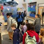 Assistant Principal Karen James, in blue t-shirt and wearing her school lanyard (center) greets students arriving at Chautauqua Elementary School. (Courtesy photo)