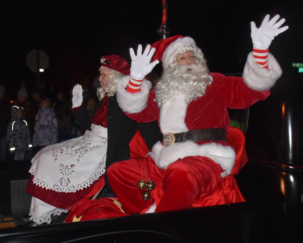 Mr. and Mrs. Claus wave to their fans as the parade rolls through town. (Jim Diers photo)