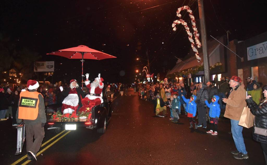 Mr. and Mrs. Claus wave to their fans as the parade rolls through town. (Jim Diers photo)
