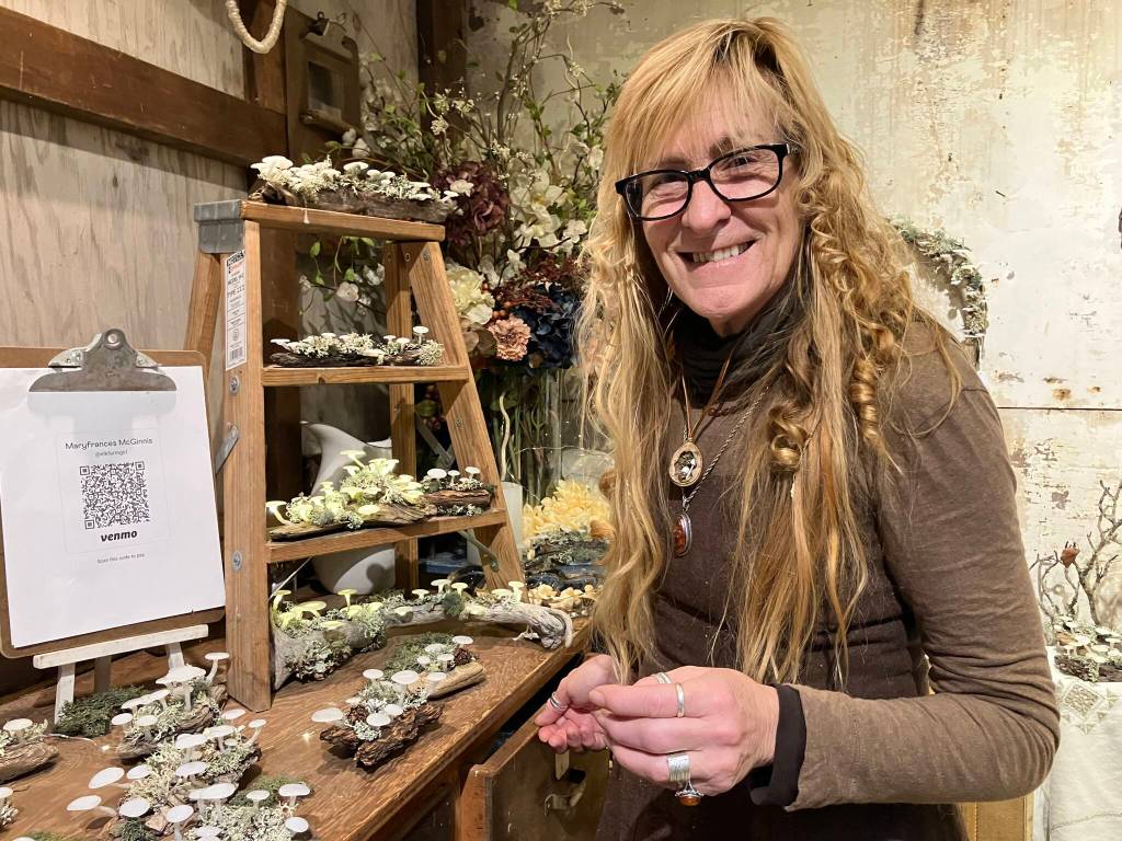 Mary McGinnis, with her magical artwork depicting mushrooms. (Elizabeth Shepherd photo)