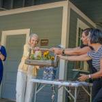 From left to right: Lynn Greiner, Kay Longhi, Teresa Mosqueda and Jennifer Meisner. In this photo, Mosqueda passes a basket to the Friends of Mukai representing the physical transfer of the barreling plant property back to the Vashon community. (Alex Bruell photo)