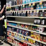 (Left to right) Alana Bass, Amelia Medeiros, Annabelle Moeckel, and school nurse and track coach Brandi Greenidge sit together after the school board meeting. In an emotional appeal, the three students urged the board not to cut Greenidges job. (Elizabeth Shepherd photo)
A store worker cleans the coffee aisle of Thriftway near the empty spot where Monastery Blend Coffee had been displayed. (Elizabeth Shepherd photo)