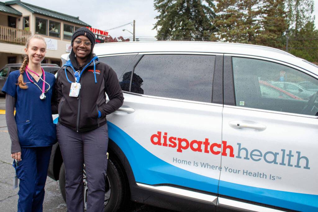 EMT Bailey Black and nurse practitioner Christian Graves stand next to their DispatchHealth van in Vashon. (Alex Bruell photo)